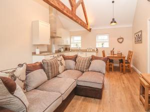 a living room with a couch and a kitchen at The Parlour in Chester