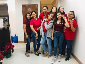 a group of women posing for a picture in a room at The Wharf Transient Hotel in Batangas City