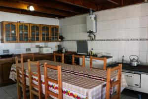 a kitchen with a table and chairs in it at Ruca de Cura in Cobquecura