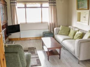 a living room with a couch and a table at Castle View in Oughterard