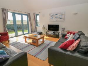 a living room with a couch and a table at Atlantic Reach in Bude