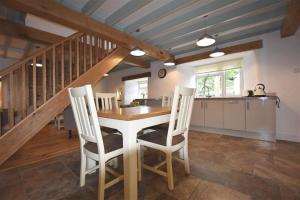 a kitchen and dining room with a table and chairs at The Old Farmhouse Kitchen in Haverfordwest +19 photos
