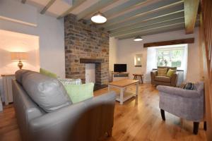 a living room with a couch and a fireplace at The Old Farmhouse Kitchen in Haverfordwest