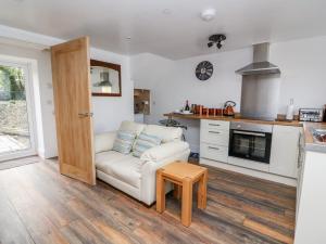 a living room with a couch and a table at Field View in Llanybydder