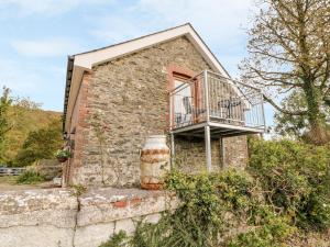 a brick house with a balcony on the side of it at Field View in Llanybydder