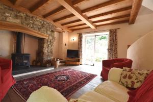 a living room with a couch and a fireplace at Cwmbrandy Cottage in Fishguard