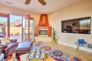 a living room with a couch and a fireplace at Lavish Escape with Pool 1 Mi to Old Town La Quinta! in La Quinta