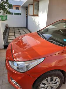 a red car parked in front of a garage at Yaa Residency near VIT in Vellore