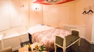 sypialnia z łóżkiem, stołem i krzesłami w obiekcie Restay SaKuRa (Adult Only) w mieście Hakodate