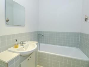 a bathroom with a sink and a bath tub at High Banks in Dartmouth +25 photos
