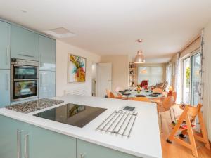 a kitchen and dining room with a white counter top at High Banks in Dartmouth