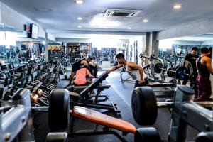 a group of people in a gym with machines at Queenco Hotel & Casino in Sihanoukville