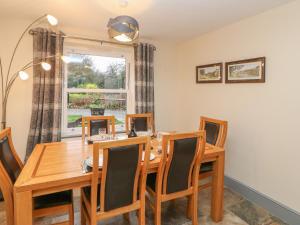 a dining room with a table and chairs and a window at Sycamore Cottage in Yarm