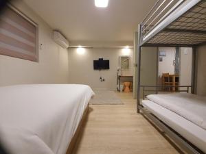 A bed or beds in a room at Daol Guesthouse