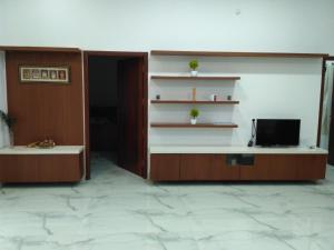 a room with a desk with a tv in it at Yaa Residency near VIT in Vellore