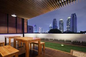 a patio with tables and a view of the city at Sakura Terrace in Jakarta