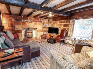 a living room with a couch and a fireplace at Brook House in Stafford