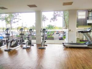a gym with a bunch of treadmills and elliptical machines at New Furnished 2BR Apartment at Silkwood Residence By Travelio in Tangerang