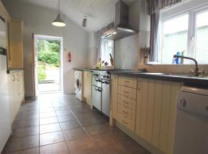 a kitchen with a sink and a stove top oven at The Farmhouse in Newport Pembrokeshire