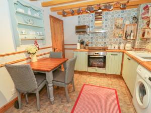 a kitchen with a wooden table and chairs in it at Linden Lea in Kirkby Stephen