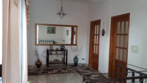 a hallway with a mirror and vases in a room at Vila Sula Guesthouse in Durrës
