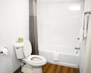 a bathroom with a toilet and a bath tub at Motel 6-Chilhowie, VA in Chilhowie