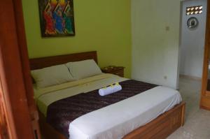 Postel nebo postele na pokoji v ubytování Made Roejas Homestay