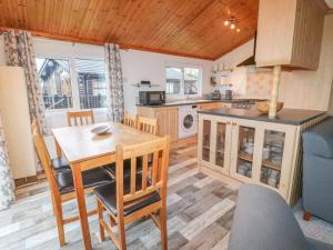 a kitchen and dining room with a table and chairs at Smugglers Shack in Polperro