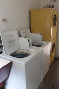 two washing machines are sitting in a room at Oasis Inn Apartments in Cairns