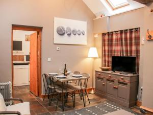 a kitchen and dining room with a table and a dining room at Hightree Lodge Barn in Craven Arms