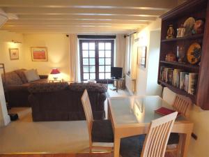 a living room with a couch and a table at Cockshead Cottage in Saint Dogmaels