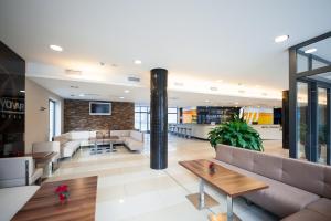 a lobby with couches and tables in a building at Hotel Pivovar in Prague