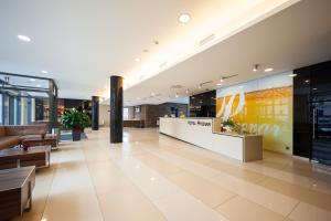 a lobby of a building with a store at Hotel Pivovar in Prague