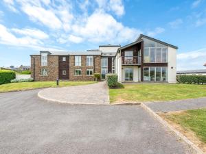 a large brick house with a driveway at 7 Ocean's Edge in Kingsbridge