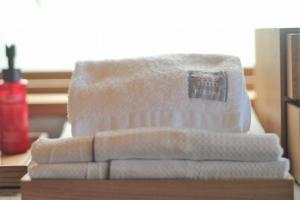 a pile of towels sitting on top of a table at KAWASEMINOSU (MUKAKA VILLA) in Nago +15 photos