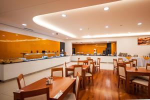 a restaurant with wooden tables and a bar at Hotel Pivovar in Prague