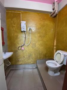 a bathroom with a toilet and a sink at Smile Guesthouse Krabi in Krabi