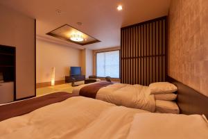 A bed or beds in a room at Niseko Prince Hotel Hirafutei
