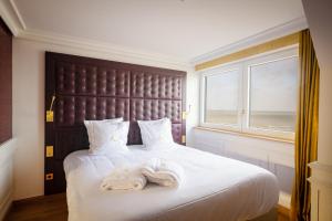 Postel nebo postele na pokoji v ubytování Hôtel Merveilleux Côté Mer