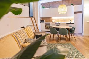 a living room with a couch and a table at Bravissimo Sacsimort in Girona
