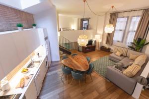 a kitchen and living room with a table and a couch at Bravissimo Sacsimort in Girona