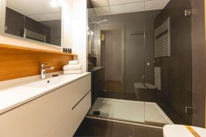 a bathroom with a sink and a shower at Bravissimo Sacsimort in Girona +28 photos