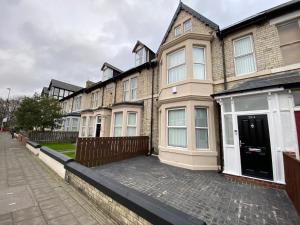 a row of houses on a brick street at Heaton Park Road Professional Lets in Newcastle upon Tyne