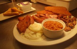 a plate of breakfast food with eggs beans and toast at The Swan in Thornbury