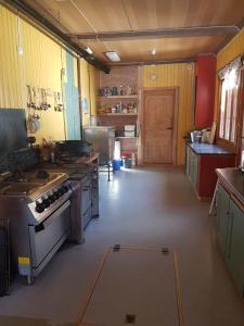 a large kitchen with a stove top oven in it at Jønndalen Høyfjellseter in Uvdal