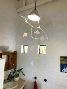 a light fixture hanging over a sink in a kitchen at Artist's Attic in Nelspruit