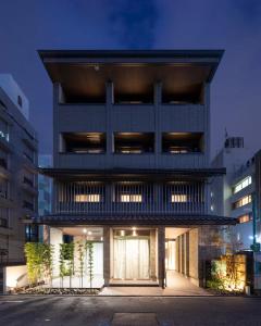 ein hohes Gebäude mit einer beleuchteten Fassade in der Nacht in der Unterkunft Kyohotel Kishotei Goshominami in Kyoto