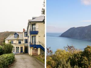 a house on a road next to a body of water at Blue Bay in Lynton