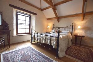 a bedroom with a bed in a room with a window at Panteurig Farmhouse in Goodwick