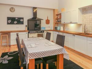 a kitchen with a table and a table and chairs at Wye Apartment, Litton Mill in Buxton